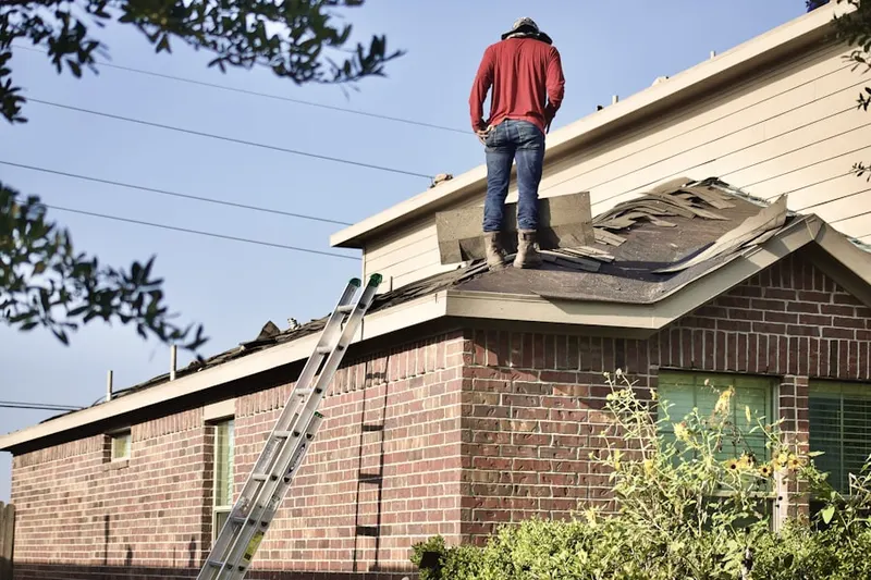 Professional roofer working on a residential roof in Marlow Heights
